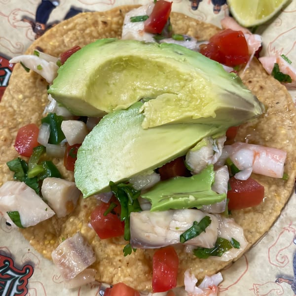Los Homies Taqueria ceviche tostada with fish, shrimp, avocado, tomatoes, and cilantro.